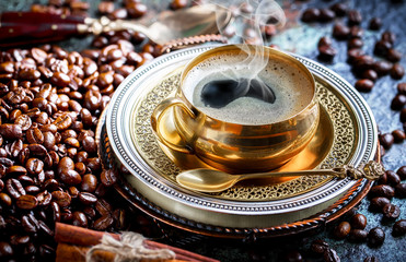 Black coffee in a cup on old background