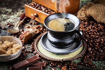 Black coffee in a cup on old background