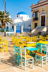 Tables and chairs at main square of Chora in Serifos island. Cyclades, Greece