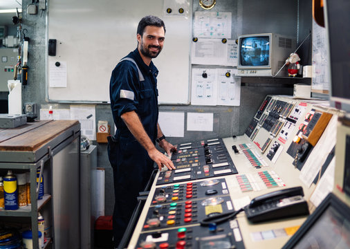 Marine engineer officer in engine control room ECR. Seamen's work. He starts or stops main engine of ship