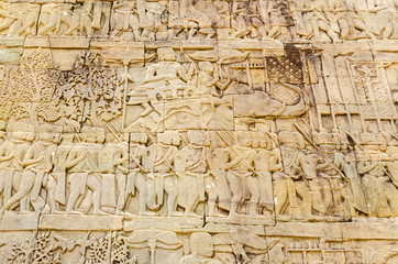 Fototapeta na wymiar A scene from the gallery of the Bayon temple in Angkor Thom showing a Khmer army on the march