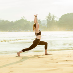Fototapeta na wymiar girl doing yoga on the beach