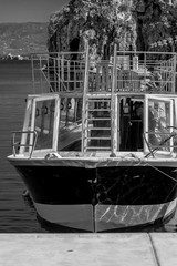 A boat on hoceima city in harbor in black and white
