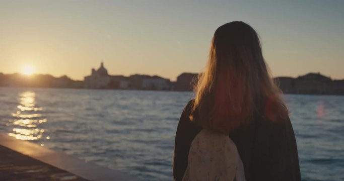 Woman looking at sunrise in Venice
