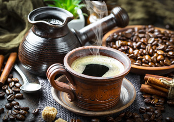 Black coffee in a cup on old background