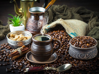 Black coffee in a cup on old background