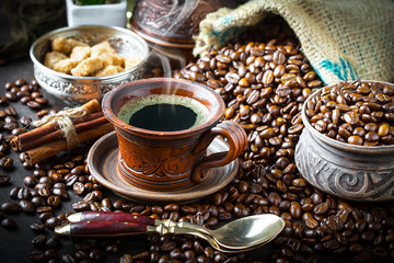 Black coffee in a cup on old background