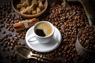 Black coffee in a cup on old background