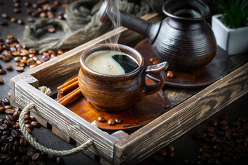 Black coffee in a cup on old background