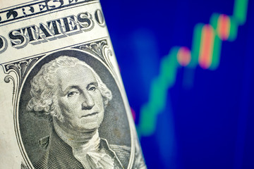 The concept of growth of the US dollar exchange rate. One dollar on a blue chart background.