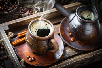 Black coffee in a cup on old background