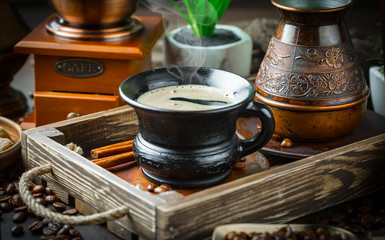 Black coffee in a cup on old background