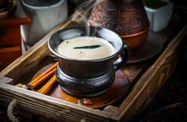 Black coffee in a cup on old background