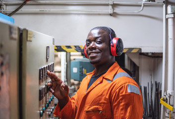 Marine engineer officer in engine control room ECR. Seamen's work. He starts or stops main engine of ship