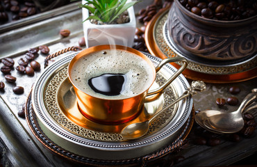 Black coffee in a composition with kitchen accessories