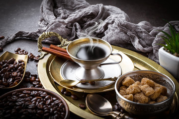 Black coffee in a cup on old background