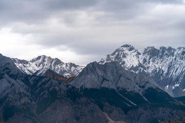 Fototapeta na wymiar Snow covered distant peaks in the foothills of the Rockies early in winter