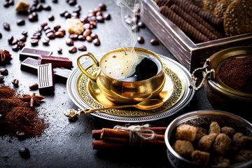 Black coffee in a cup on old background
