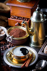 Black coffee in a cup on old background