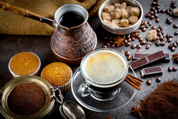 Black coffee in a cup on old background