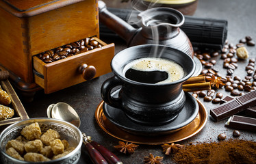 Black coffee in a cup on old background