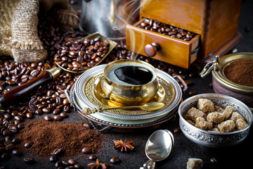 Black coffee in a cup on old background
