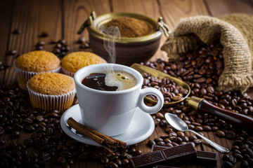 Black coffee in a cup on old background