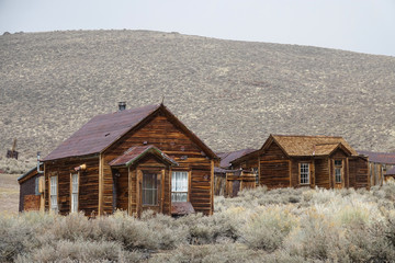 Abandoned wooden cabins slowly decay in the tough weather in Californian wild.