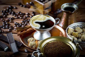 Black coffee in a cup on old background