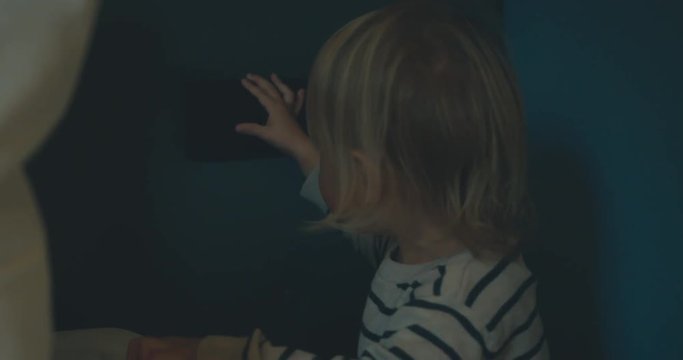 Little toddler turning the light on and off
