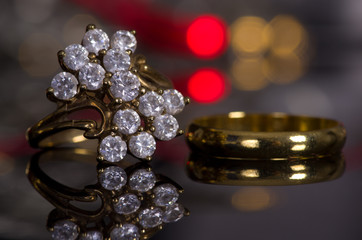 Golden ring on a gray background with a mirror image.