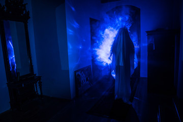 Horror silhouette of ghost inside dark room with mirror Scary halloween concept Silhouette of witch...