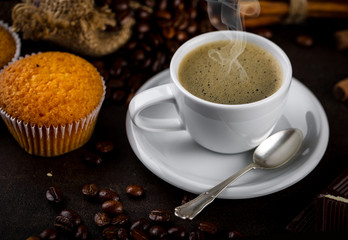 Black coffee in a cup on old background
