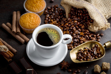 Black coffee in a cup on old background