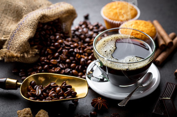 Black coffee in a cup on old background