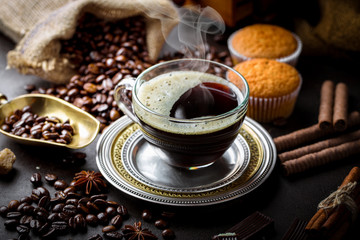 Black coffee in a cup on old background