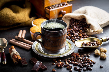 Black coffee in a cup on old background