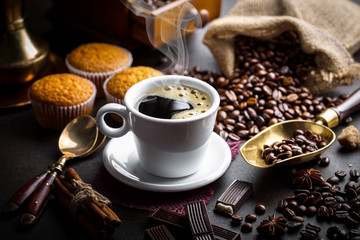 Black coffee in a cup on old background