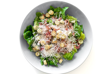 Caesar salad with bacon, cheese, salad, bred and chicken