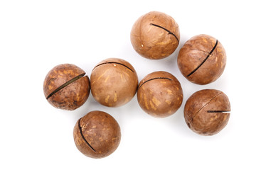 unshelled macadamia nuts isolated on white background. Top view. Flat lay pattern