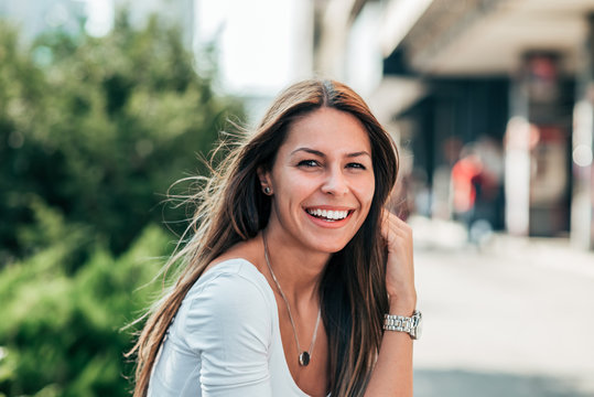 Portrait of gorgeous smiling young woman outdoors.