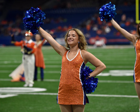 Young College Cheerleader Performing At A College Football Game