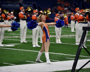 Young college cheerleader performing at a college football game © Joe