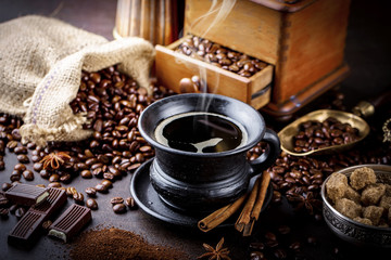 Black coffee in a cup on old background