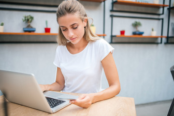 Girl using laptop and credit card.