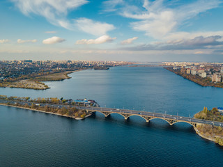 Fototapeta premium Aerial autumn Voronezh cityscape from drone flight height. View of the bridge over Voronezh Water Reservoir