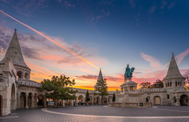 Fototapeta premium Budapest, Hungary - Fisherman's Bastion (Halaszbastya) and statue of Stephen I. with colorful sky and clouds at sunrise