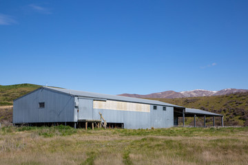 Fototapeta na wymiar An iron woolshed or shearing shed on a farm in the high country of New Zealand