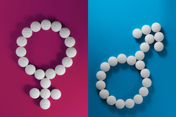 Drugs on a blue and pink background in the form of signs of Venus and Mars. Сoncept of the...