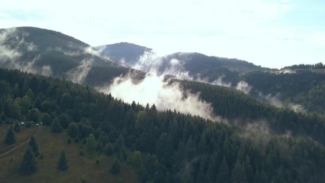 Overhead Aerial Drone Shot Pulling Back Revealing Moving Valley Fog on a Romanian Mountainside.